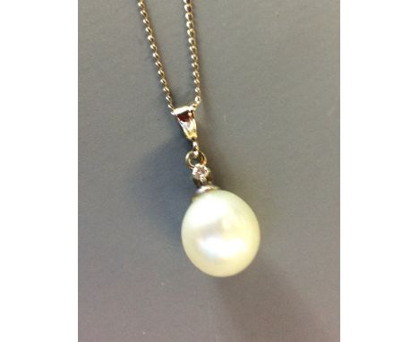 A 9CT WHITE GOLD, DIAMOND AND PEARL PENDANT DROP Having a single pear shape pearl, set with a round cut diamond on a fine whi
