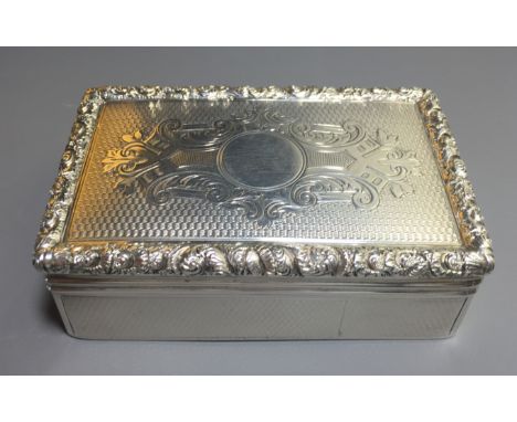 A LARGE VICTORIAN SILVER SNUFF BOX The engine turned lid centred by engraved 'C' scroll decoration, contained within a cast f