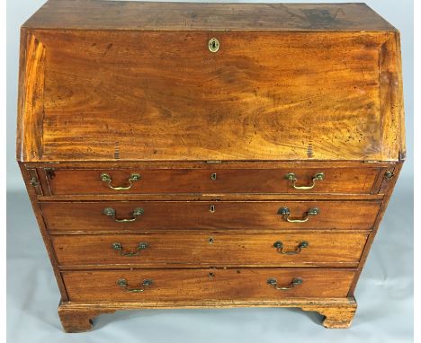A 19TH CENTURY MAHOGANY WRITING BUREAU The fall front enclosing a fitted and shelved interior, over four graduated drawers, r