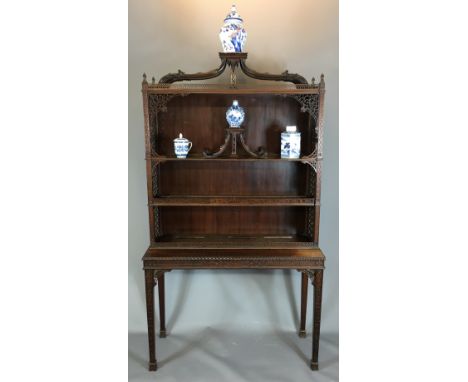 A LATE 19TH/EARLY 20TH CENTURY CHINESE CHIPPENDALE MAHOGANY DISPLAY CABINET ON STAND Carved and pierced fret work decoration.