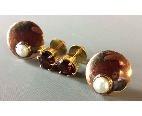 A VINTAGE PAIR OF 9CT GOLD AND GARNET STUD EARRINGS  Each having an oval cut stone claw set on a plain shank, together with a