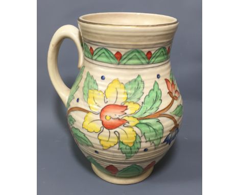 CHARLOTTE RHEAD, A 20TH CENTURY POTTERY JUG With tube lined foliate decoration on a cream ground. (h 27cm)