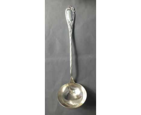 A LATE 19TH/EARLY 20TH WHITE METAL SOUP LADLE With foliate and scroll decoration to the handle.