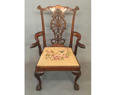 AFTER CHIPPENDALE, AN EARLY 20TH CENTURY MAHOGANY OPEN ARMCHAIR With shaped serpentine rail over ribbon carved back splat and