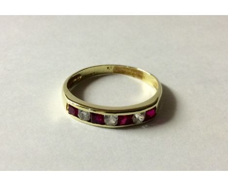 A 14CT GOLD, RUBY AND PASTE HALF HOOP RING Alternating square cut rubies and round cut white paste stones, all channel set to