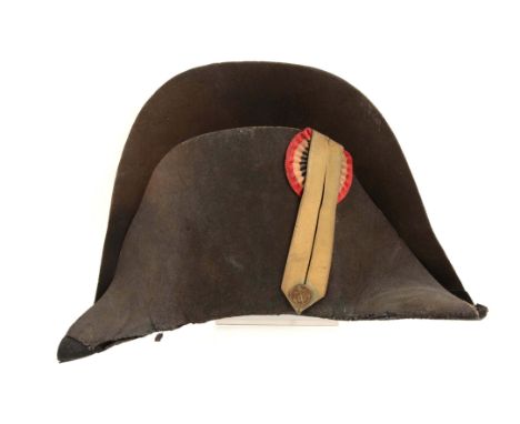 The officer's high-rise bicorn chapeau of black felt with black leather chinstrap and brown leather sweatband. Lining missing