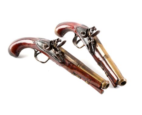 Unmarked, two-stage brass cannon barrels with rounded flint locks and typical engraved French brass furniture.  Walnut stocks