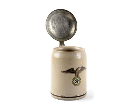 Stein measures 5-1/2" tall, 3-3/4" at base. Made of ceramic, half litre capacity with German eagle and Swastika on face. The 