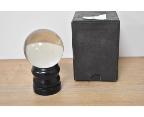 A vintage crystal ball with stand and box.