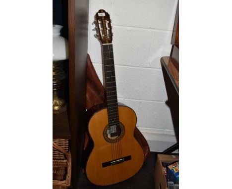 A vintage acoustic guitar.
Kasuga instruments, soft case included.
