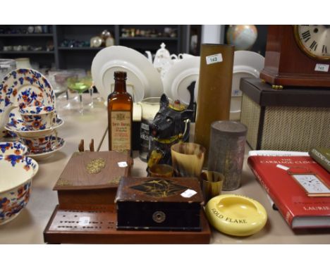 A brass trench art shell vase, horn beakers, a cribbage board, a Scottie dog money bank, and other items