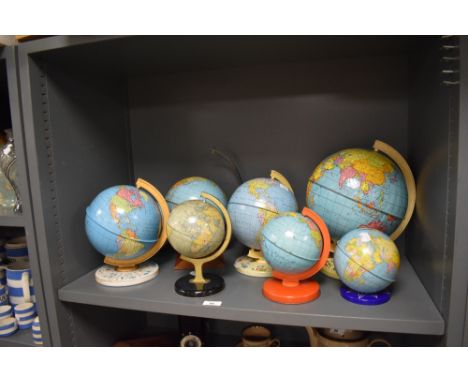 Seven vintage children's tin globes.
