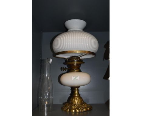 A 20th century oil lamp, having opaque glass shade and reservoir.