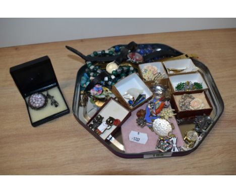 A tray of miscellaneous costume jewellery and badges, including wedding cake beads, wristwatches, brooches, and enamelled ite