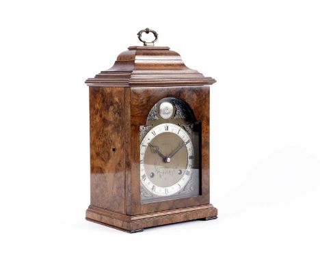 A mid-20th Century mantel clock by Elliott London, the arched brass dial with a silvered chapter ring and Roman numerals, dec