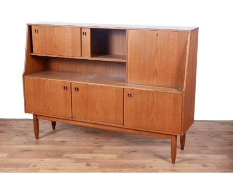 Portwood Furniture of Stockport: a mid-20th Century teak sideboard, the left-hand side with sliding cupboard doors above stor