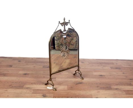 A Victorian brass fire screen, with bevelled mirror plate with sunburst detailing, and urn and garland motif, 45 x 78cms high