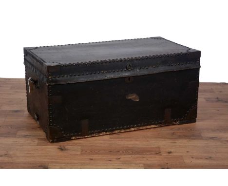 An early 20th Century leather and metal bound steamer trunk/blanket box, with metal capped corners and studded edging through