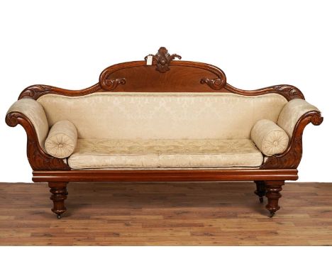 A Victorian carved walnut and mahogany sofa, with foliate and scroll top rail and carved floral cresting, carved foliate scro