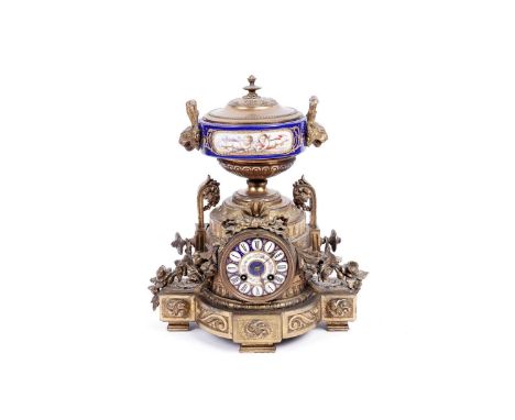 A 19th Century French ormolu mantle clock, by Brunfaut, the white and blue enamel floral painted Roman dial within an ormolu 