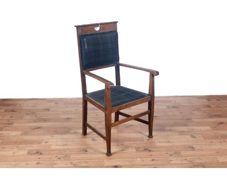 Shoolbred and Co. Tottenham: an early 20th Century oak Arts and Crafts armchair, with moulded cornice, raised on tapered legs