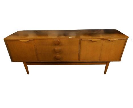 A mid-20th Century teak sideboard, with central bank of three drawers. full front cupboard door to the left opening to reveal