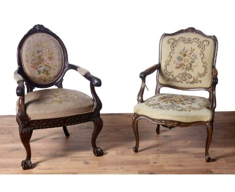 A Victorian-style carved mahogany armchair, with flower and floral carving throughout, floral tapestry seat pad and backrest;