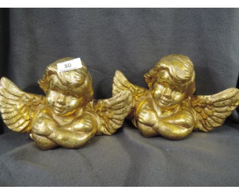 A pair of ceramic angel or cherubs with gold gilt style finish ideal for Christmas decoration