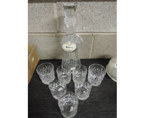 An ornate cut glass decanter in the form of a Scotch thistle with glasses