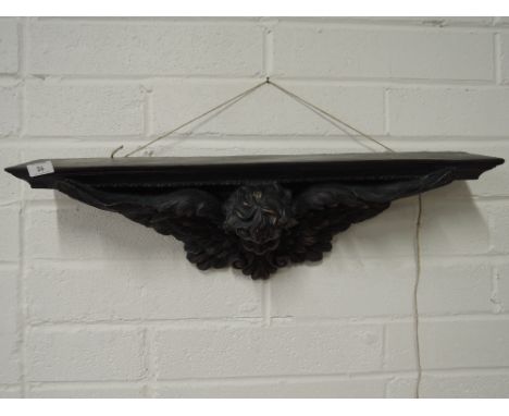 A flush fitting wall shelf in a regency style with winged cherub