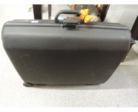 A large Samsonite travel trunk suitcase with hard plastic body