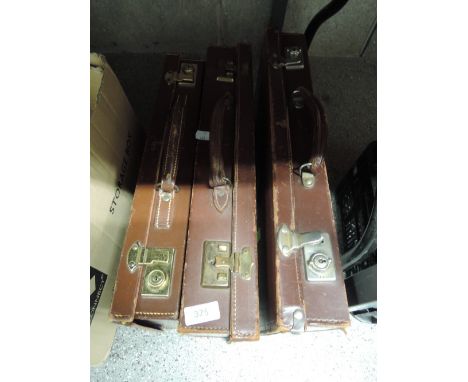 A selection of small childrens style leather travel trunk suitcases 