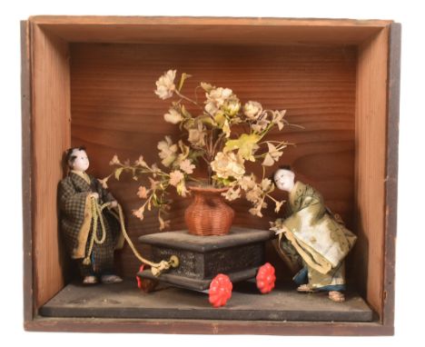 Dolls - a vintage Japanese doll case containing x2 wooden porcelain covered Japanese figures wearing traditional Kimonos whil