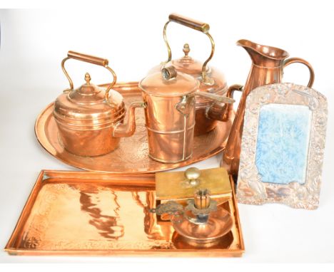 Copper ware including Eastern circular tray, kettles, Arts &amp; Crafts chamberstick, pan with hinged lid and riveted handle 