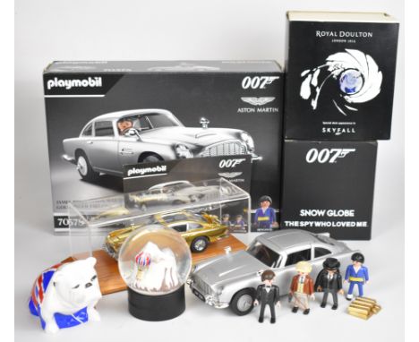 James Bond 007 related items comprising a Danbury Mint Aston Martin DB5 diecast model car with display case, Playmobil DB5 Go