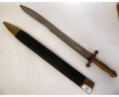 A mid 19thC sawback sword with a ribbed brass, elliptical handgrip and crossguard, the blade 19"L in a hide bound sheath (Ple