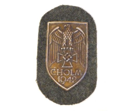 A German Cholm 1942 arm shield (Please Note: this lot is subject to the statement made in the Auctioneers Glossary of Certain