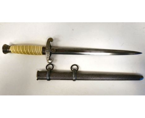 A German Army officer's dagger with a cream coloured wrythen moulded grip and spreadeagle emblem on the crossguard&nbsp; the 