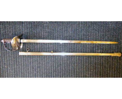 An Edwardian VII dress sword with a pierced and silvered guard and a wire bound hide handgrip, the engraved blade 31"L, in a 