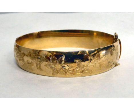 A yellow metal bangle&nbsp; bearing indistinct marks