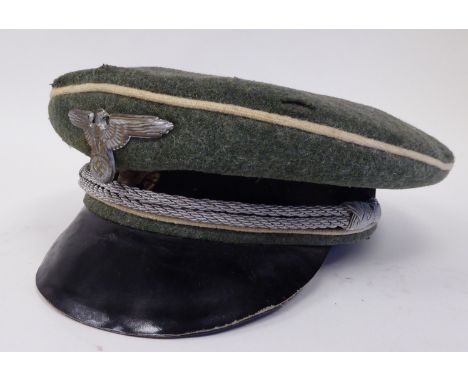 A German SS green and black peaked cap with white piping, emblems and a silvered cord (Please Note: this lot is subject to th