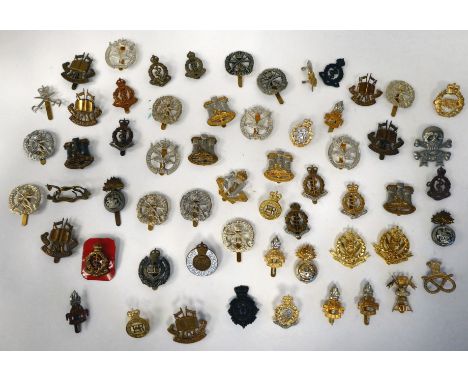 Approximately fifty British military cap badges: to include Army Educational Corps; Glider Pilot Regiment; and Royal Engineer