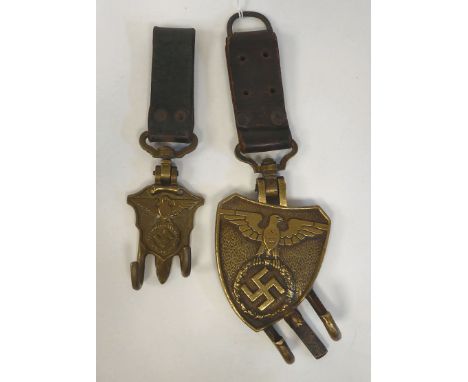 A pair of German brass and brown hide drum hangers (Please Note: this lot is subject to the statement made in the Auctioneers