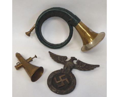 A German Nazi era brass horn; a bronze cycling horn; and a spreadeagle and swastika iron vehicle emblem&nbsp; 9"w (Please Not