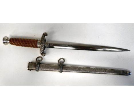 A German Army officer's dagger with an orange coloured wrythen moulded grip and spreadeagle emblem, on the crossguard&nbsp; t