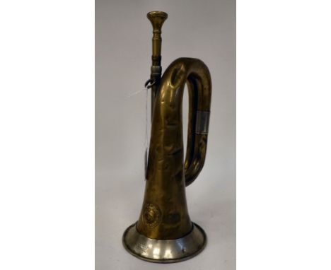 A German brass bugle with an impressed eagle and swastika emblem (Please Note: this lot is subject to the statement made in t