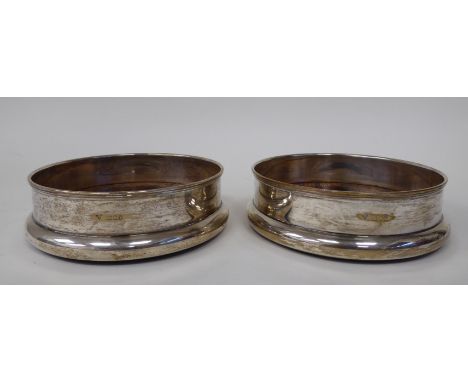 A pair of modern silver wine coasters with hardwood bases&nbsp; Brian Leslie Fuller&nbsp; London 1975&nbsp; 5"dia