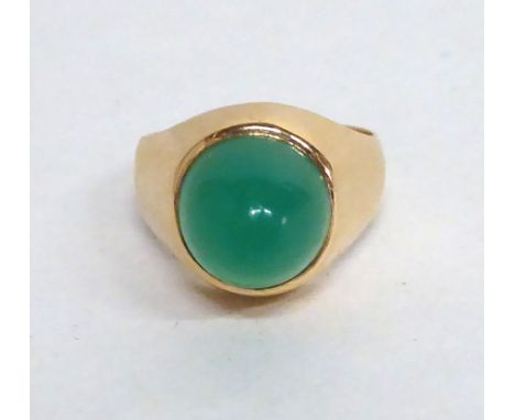 An 18ct gold ring, set with a cabochon cut green stone
