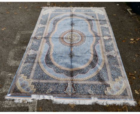 A Persian pure silk rug, profusely decorated with repeating intricate floral designs, on a mainly blue ground&nbsp; 80" x 116