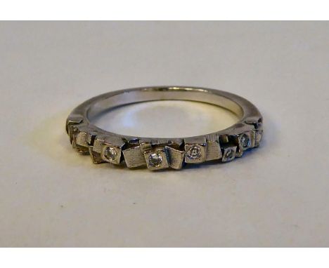 An 18ct white gold ring, randomly set with six small diamonds